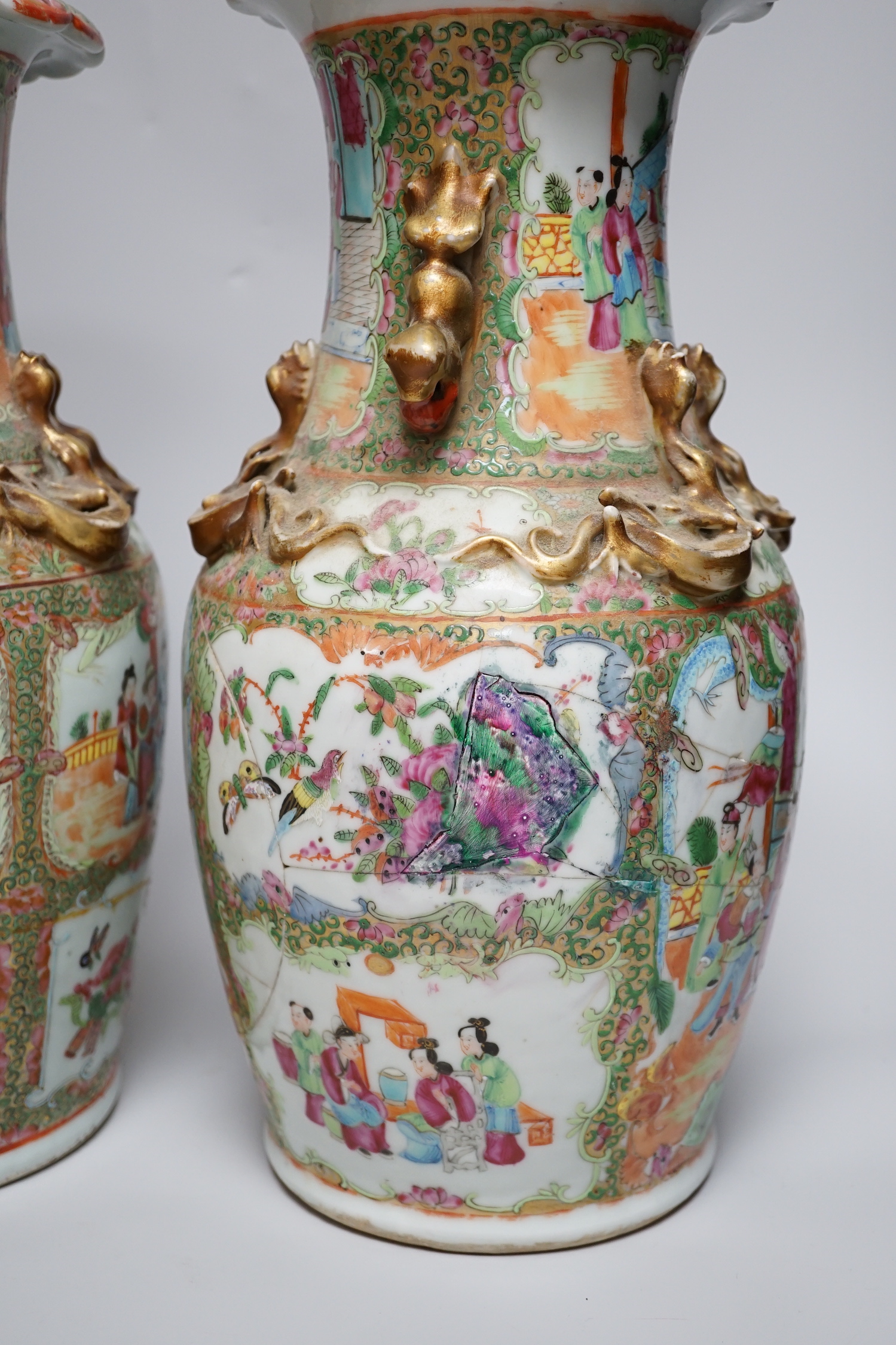 A pair of Chinese Canton decorated famille rose enamelled vases, 36cm high, an early 20th century Chinese blue and white baluster vase, 25cm (a.f.), a 19th century Chinese blue and white gu shaped vase, 37.5cm (a.f.), a